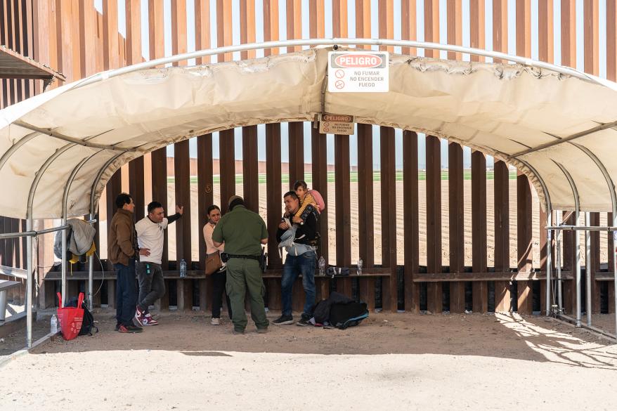 Migrants getting processed by a Border Patrol agent in San Luis.