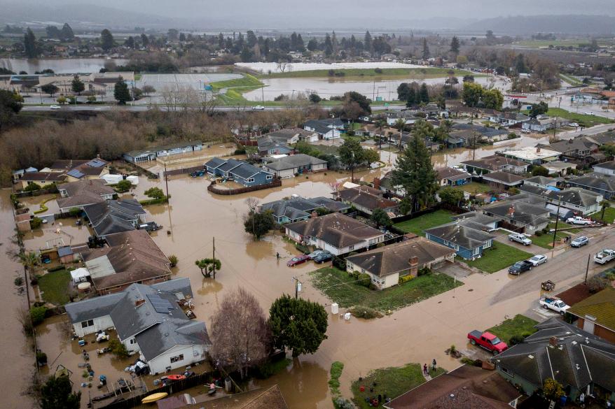 Flooding from huge amounts of rain are seen in a neighborhood off of Holohan Road near Watsonville, Calif.