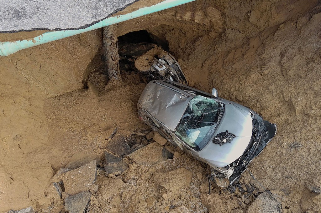 The excessive rain caused the car to turn and shift in the hole.