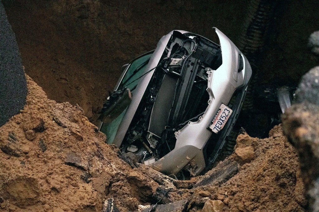 The turned-over car in the mud.