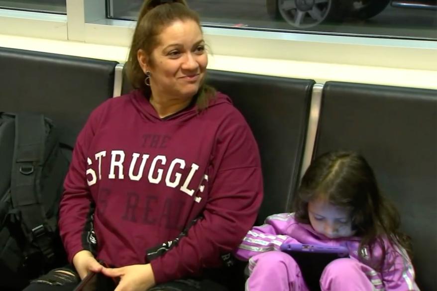 The Argueta family sits in the airport.