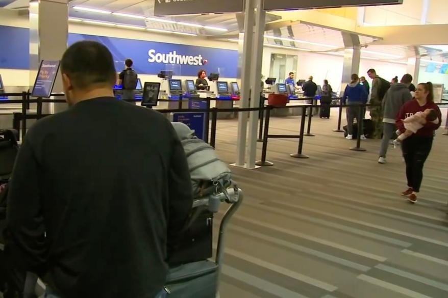 The Argueta family sits in the airport.