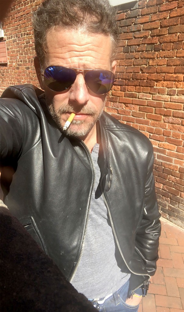 Hunter Bidden is seen with a cigarette dangling from his mouth and wearing a leather jacket 