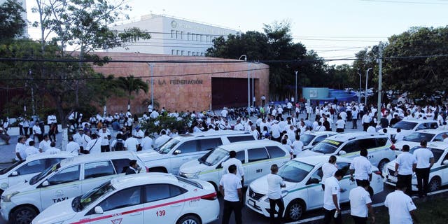 Taxi drivers hold a protest against the regulation of taxi-hailing apps such as Uber in Cancun, Mexico, on Jan. 11, 2023.