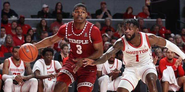 Hysier Miller #3 of the Temple Owls dribbles the ball baseline around Jamal Shead #1 of the Houston Cougars at Fertitta Center on January 22, 2023 in Houston, Texas. 