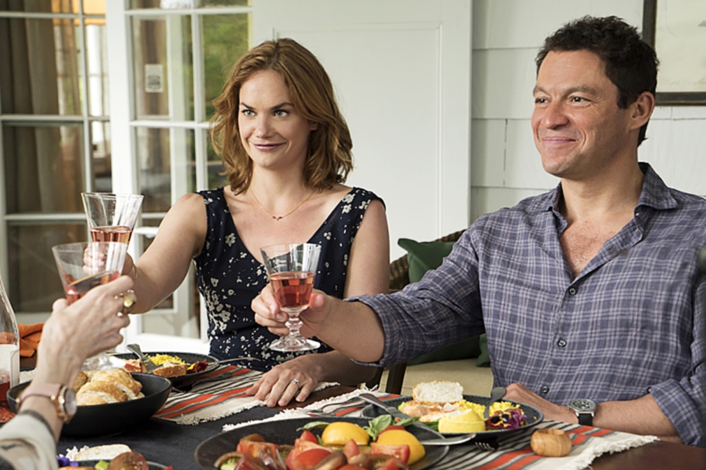 Ruth Wilson and Dominic West in "The Affair," eating at a table toasting drinks. 