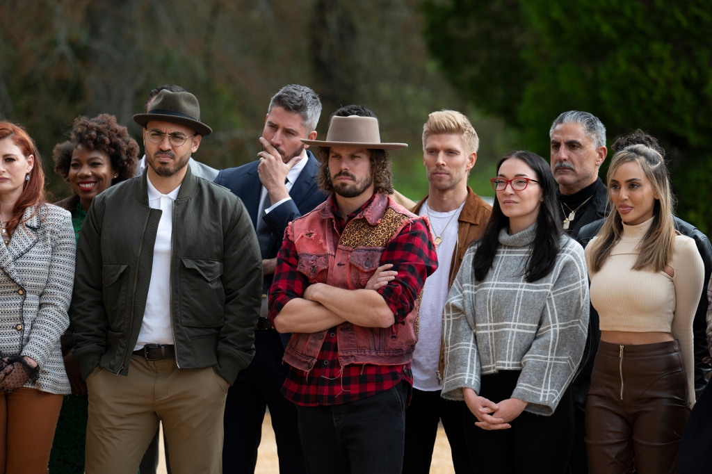 Rachel Reilly, Shelbe Rodriguez, Robert "Bam" Nieves, Arie Luyendyk Jr., Christian De La Torre, Kyle Cook, Amanada Clark, Reza Farahan, Azra Valani in "The Traitors" stand in a driveway. 