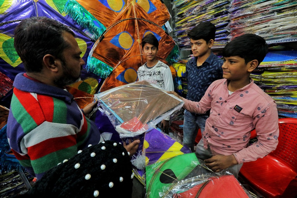 People buying paper kites at Hanipura Kite Market on the occasion of  the Makar Sankranti festival, in Jaipur, Rajasthan, India.