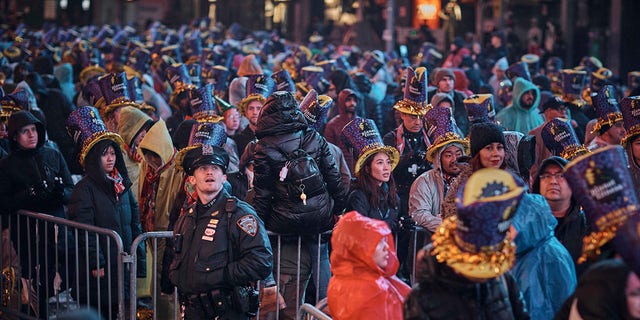 Revelers gather under the rain during the New Year's Eve celebrations in Times Square on Saturday, Dec. 31, 2022, in New York.