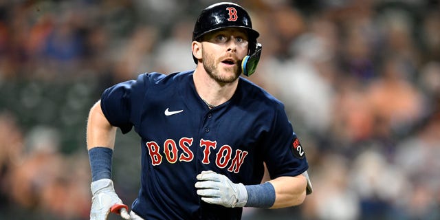 Trevor Story #10 of the Boston Red Sox runs to first base against the Baltimore Orioles at Oriole Park at Camden Yards on September 10, 2022 in Baltimore, Maryland.