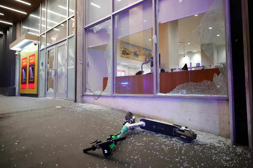 Broken windows at a Wells Fargo branch are seen following a violent protest, late Saturday, Jan. 21, 2023, in Atlanta, in the wake of the death of an environmental activist killed after authorities said the 26-year-old shot a state trooper.