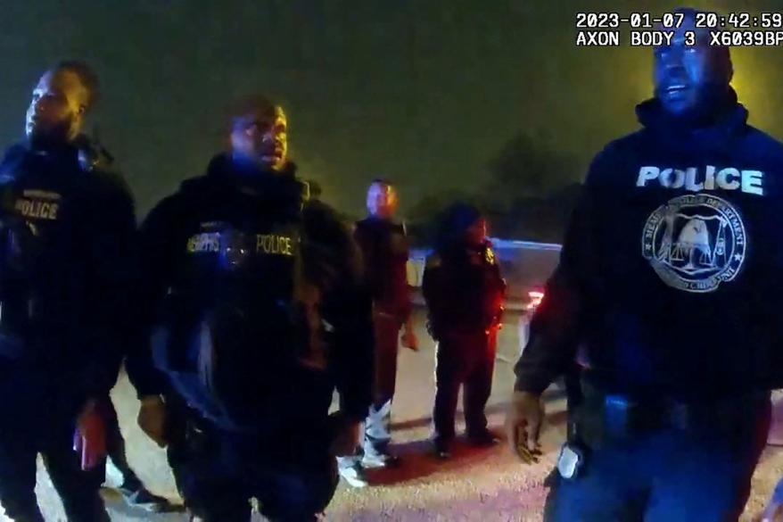 Memphis Police Department officers stand near Tyre Nichols, after they beat him.