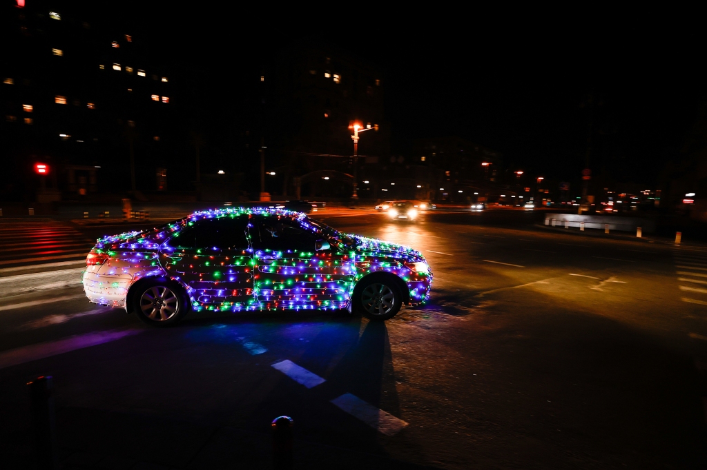 A vehicle is decorated with lights in Kyiv on New Year's Eve.