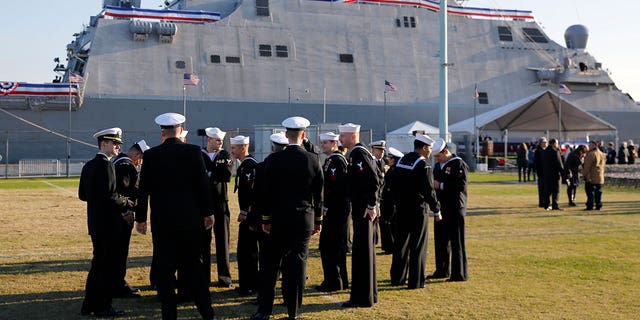 Crew members of the USS Sioux City, a Freedom-class of littoral combat ship, gather before the ship's commissioning ceremony.