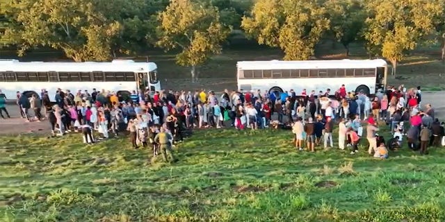 A group of illegal migrants are shown gathered at the U.S. southern border. 