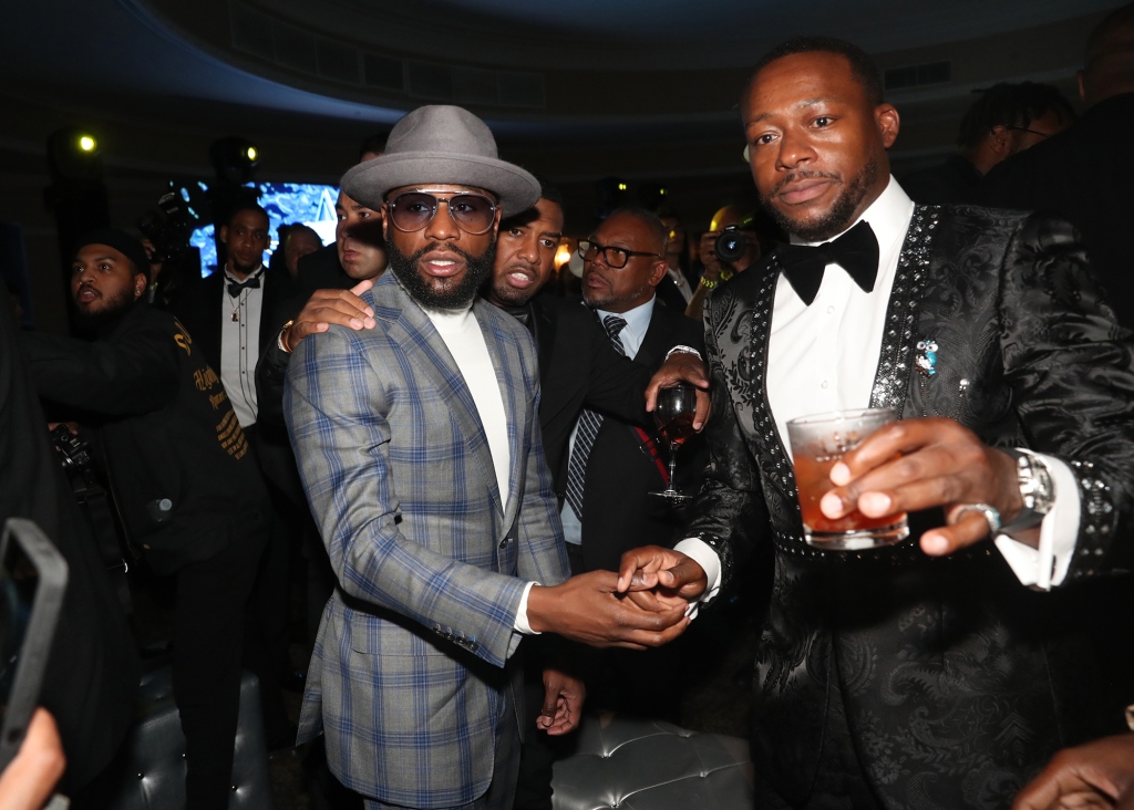 Benson (right) has posted many photos of himself rubbing elbows with celebrities like Floyd Mayweather.