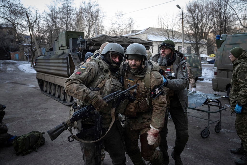 Ukrainian soldiers carrying a wounded soldier to a hospital in the Donetsk region on January 9, 2023.
