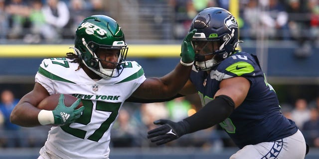 Zonovan Knight #27 of the New York Jets carries the ball against the Seattle Seahawks during the second half of the game at Lumen Field on January 01, 2023 in Seattle, Washington.