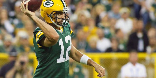 Green Bay Packers quarterback Aaron Rodgers (12) passes against the Seattle Seahawks during the first quarter at Lambeau Field. Packers won 27-17.