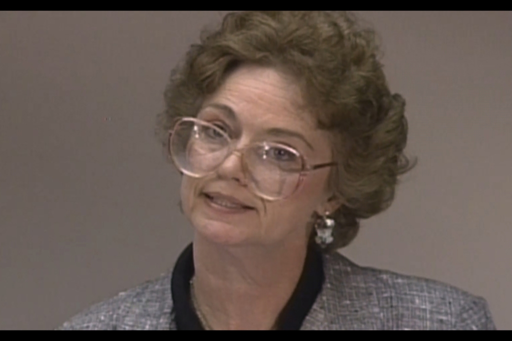 Color photograph of Caril Ann Fugate in the 1980s. She's wearing big glasses and is being interviewed by an unseen person.