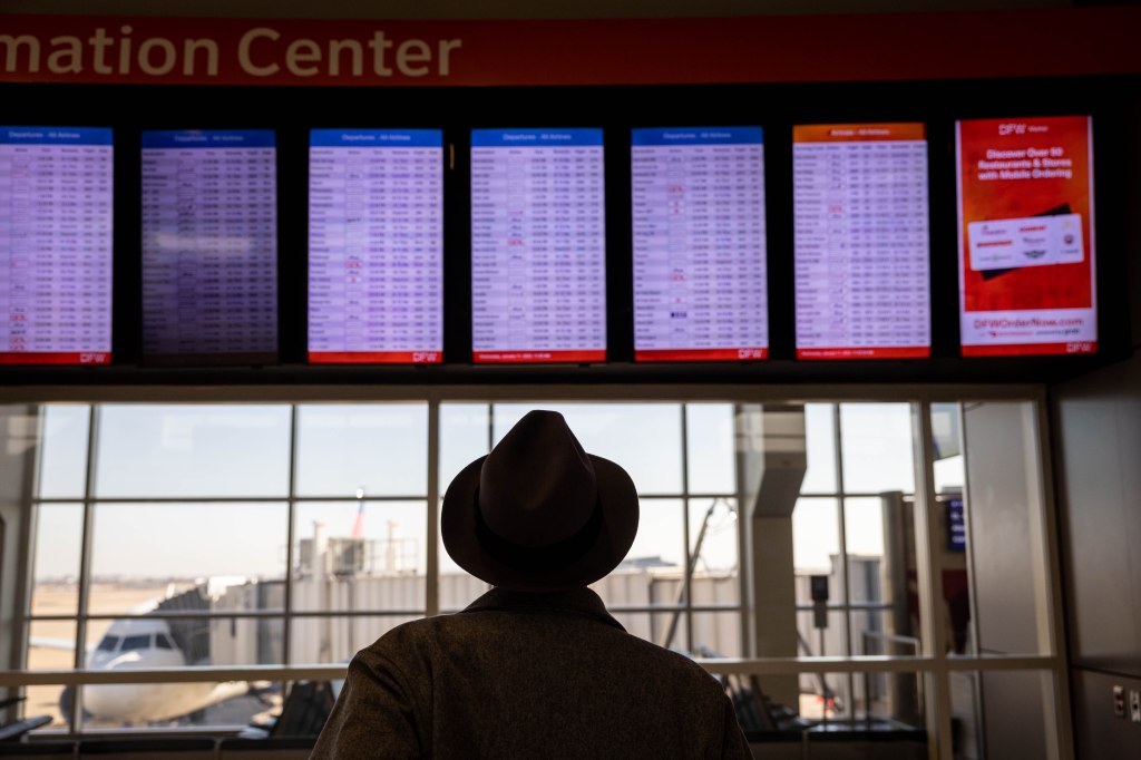 Passengers pass through Dallas-Fort Worth International Airport on Jan. 11, 2023 in Dallas, Texas. 