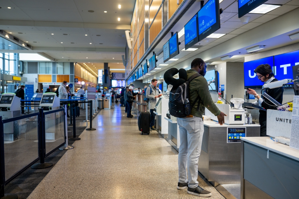 A customer speaks with a United Airlines associate over a cancelled flight at the Austin-Bergstrom International Airport on Jan. 31, 2023 in Austin, Texas.