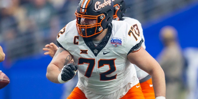 Oklahoma State Cowboys offensive lineman Josh Sills, #72, against the Notre Dame Fighting Irish during the 2022 Fiesta Bowl at State Farm Stadium in Glendale, Arizona, Jan. 1, 2022.