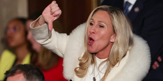 Rep. Marjorie Taylor Greene, R-Ga., gives a thumbs down during President Joe Biden's State of the Union address during a joint meeting of Congress.