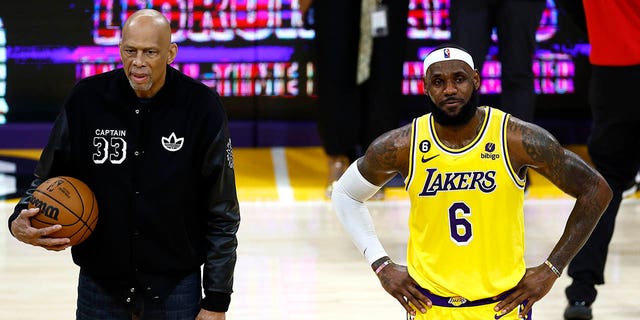 Kareem Abdul-Jabbar stands on court with LeBron James (6) of the Los Angeles Lakers after James passed Abdul-Jabbar to become the NBA's all-time leading scorer with 38,388 points against the Oklahoma City Thunder at Crypto.com Arena Feb. 7, 2023, in Los Angeles.