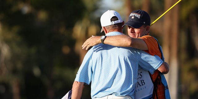 Steven Alker, of New Zealand, hugs caddie Sam Workman after winning the Charles Schwab Cup following the final round the Charles Schwab Cup Championship at Phoenix Country Club on Nov. 13, 2022 in Phoenix.