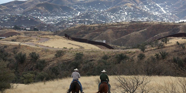 A U.S. Border Patrol ranch liaison rides with a rancher near Nogales, Arizona. George Kelly's attorney says he contacted the ranch liaison several times the day of the shooting, including to report the discovery of a body.