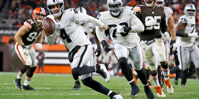 Las Vegas Raiders quarterback Derek Carr (4) runs with the ball during a game against the Cleveland Browns Dec. 20, 2021, in Cleveland. 