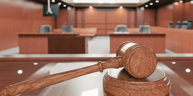 Inside a courtroom with gavel in plain view. 