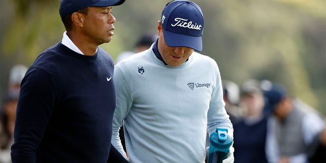 Tiger Woods and Justin Thomas walk off the ninth tee during the Genesis Invitational on Feb. 16, 2023.