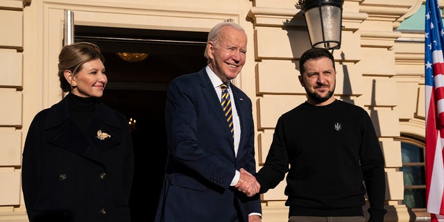 President Joe Biden, center, shook hands with Ukrainian President Volodymyr Zelenskyy, right, as they posed with Olena Zelenska, left, spouse of President Zelenskyy, at Mariinsky Palace during an unannounced visit in Kyiv, Ukraine.