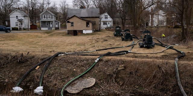 FILE: A clean-up crew works alongside a stream as clean-up efforts continue on February 16, 2023, in East Palestine, Ohio. On February 3rd, a Norfolk Southern Railways train carrying toxic chemicals derailed causing an environmental disaster. 