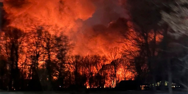 In this photo provided by Melissa Smith, a train fire is seen from her farm in East Palestine, Ohio, Friday, Feb. 3, 2023.