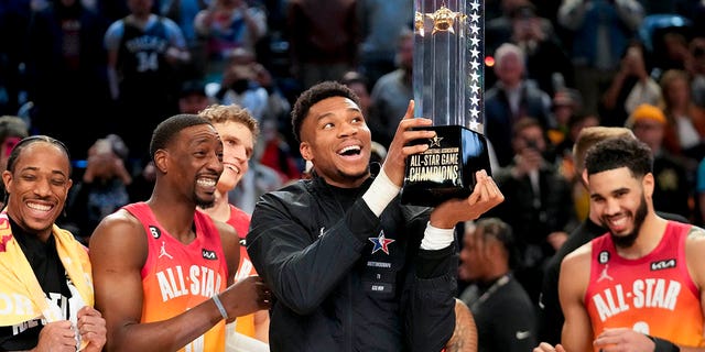 Giannis Antetokounmpo holds up the winning team trophy after the NBA basketball All-Star game Sunday, Feb. 19, 2023, in Salt Lake City.