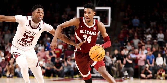 Gregory Jackson II (23) of the South Carolina Gamecocks defends Brandon Miller (24) of the Alabama Crimson Tide as he drives to the basket during a game Feb. 22, 2023, at Colonial Life Arena in Columbia, SC. 