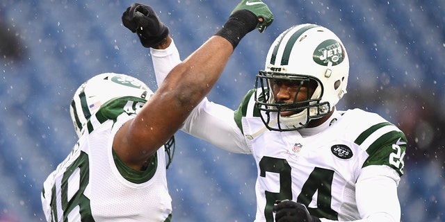 Darrelle Revis (24) of the New York Jets reacts with Jordan Jenkins (48) before a game against the New England Patriots at Gillette Stadium Dec. 24, 2016, in Foxboro, Mass.