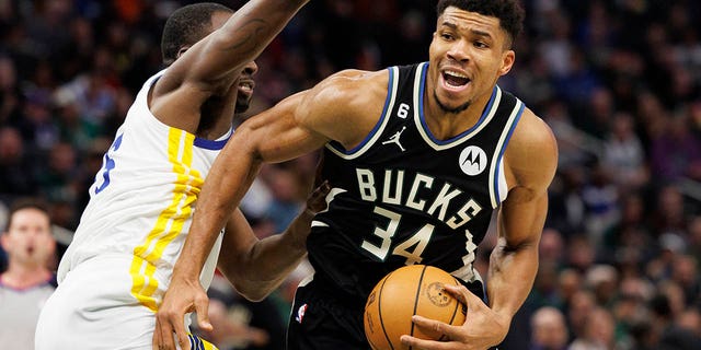 Milwaukee Bucks forward Giannis Antetokounmpo (34) drives for the basket around Golden State Warriors forward Draymond Green (23) during the third quarter at Fiserv Forum Dec 13, 2022, in Milwaukee.