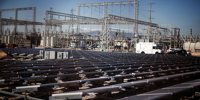 Solar panels are seen next to an electricity station in Carson, California, on March 4, 2022.