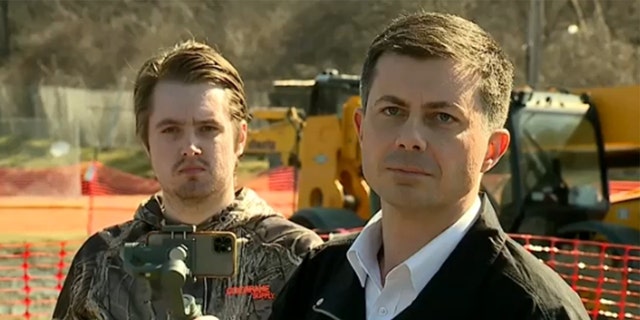 Transportation Secretary Pete Buttigieg, right, admits during a press conference that he waited too long to make a public statement on the Norfolk Southern train derailment in East Palestine, Ohio on Thursday, Feb. 23, 2023.  