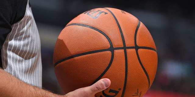 A referee holds a basketball at the Staples Center in Los Angeles, California, on Jan. 17, 2018.