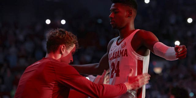 Brandon Miller #24 of the Alabama Crimson Tide is patted down by a teammate during player introductions prior to tip off against the Kentucky Wildcats at Coleman Coliseum on January 7, 2023 in Tuscaloosa, Alabama.