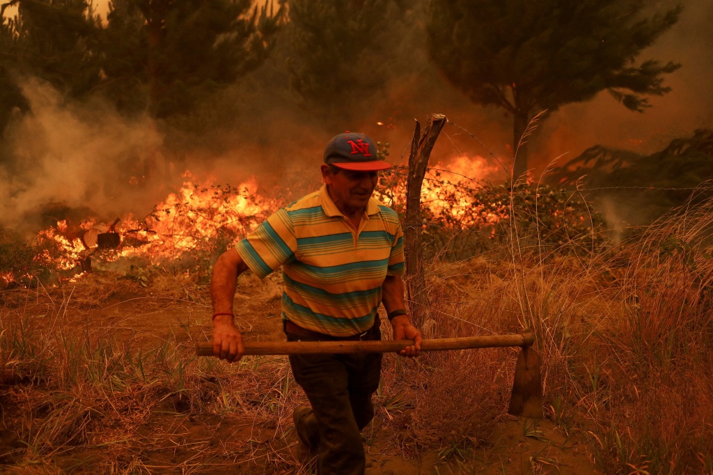 A resident in Santa Juana fights a fire on Feb. 4 in Chile.