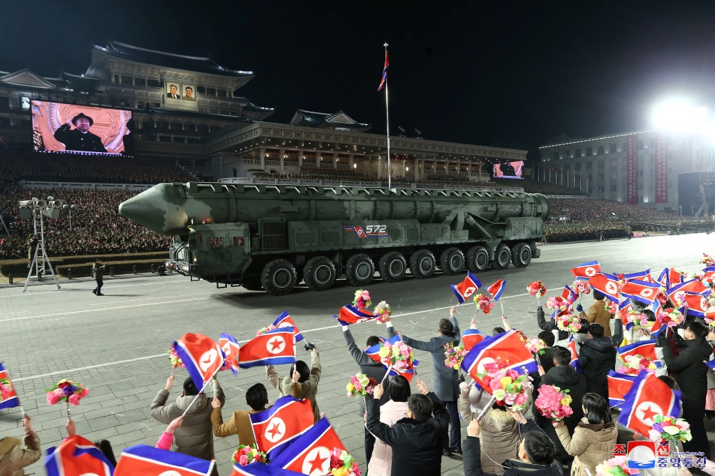 Kim Jong Un is displayed on a large screen, as a missile is rolled through Kim Il Sung Square in Pyongyang, North Korea on Feb. 8, 2023.