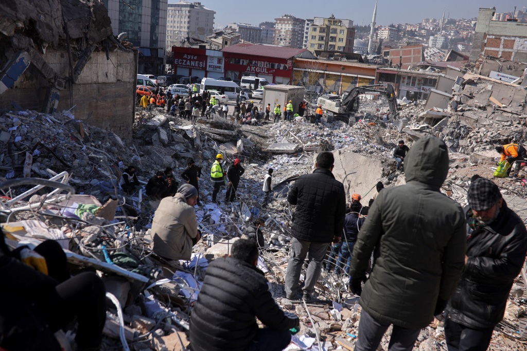 People gather as rescuers continue to search for victims and survivors trapped under the rubble in Kahramanmaras, Turkey on Feb. 9, 2023. 