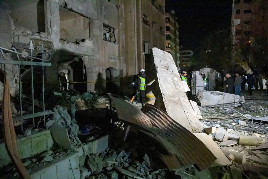 People inspect the damage from the rocket attack in Damascus, Syria on Feb. 19.