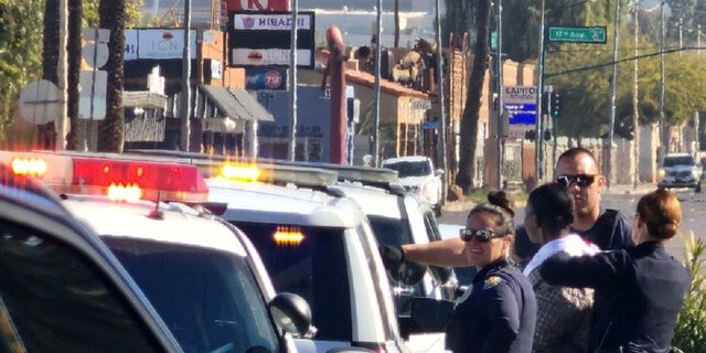 Phoenix police officers at the scene where an officer ingested a substance during a traffic stop.